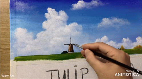 a hand writes a phrase on a painting