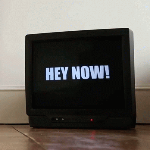 an old black television with the words hey now on it