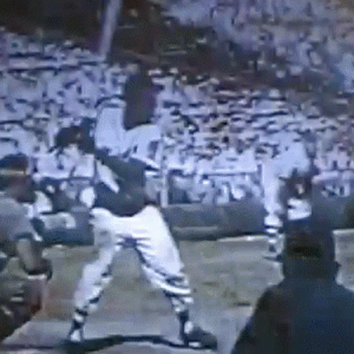 a man is swinging a bat at a baseball game