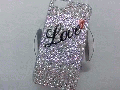 a cell phone covered in shiny silver crystals
