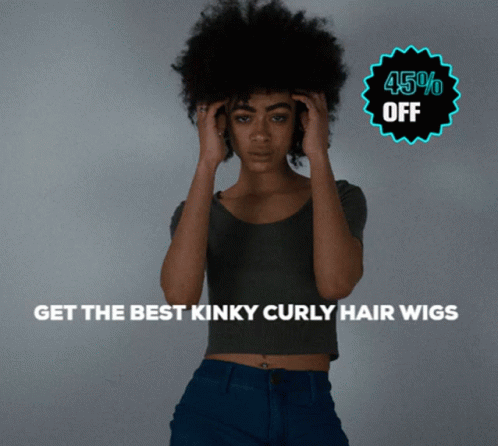 a girl with an afro stands in front of the camera and holds her head