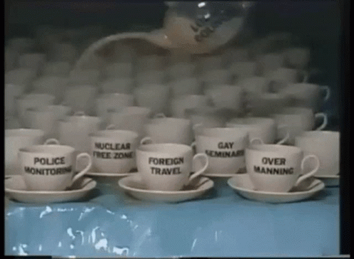 multiple cups with political slogans are stacked together