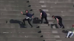 three people are walking across a set of steps