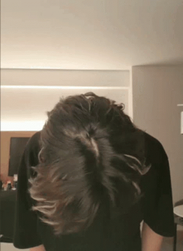 the back of a person's head with a tie on