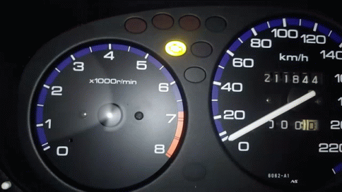 a close - up of a gauge and dash board of a car