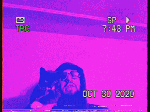there is a red television with a man holding a cat