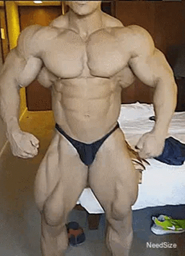 the bodybuil is posing for a picture in his underwear