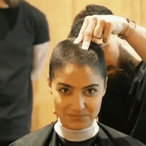 a woman in the process of getting her hair styled