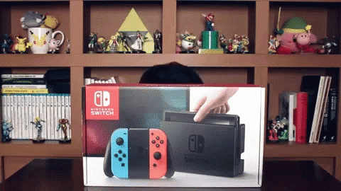 a display in front of shelves of toys with a nintendo game console and a box