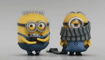 two small blue miniature toy minions one with a scarf and the other as an elf