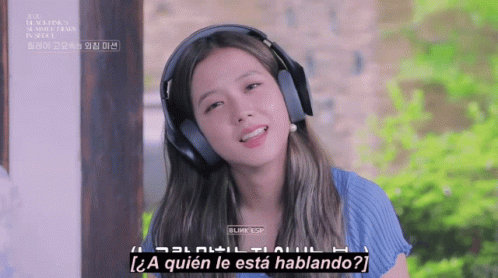an asian woman wearing headphones talking to another person