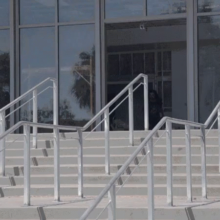 two skate boarders are skateboarding down white stairs