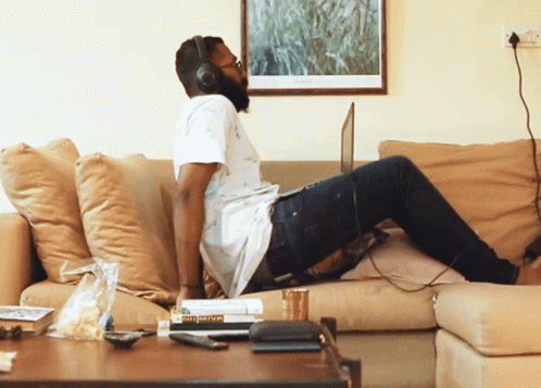 a person sitting on a couch with their legs stretched out