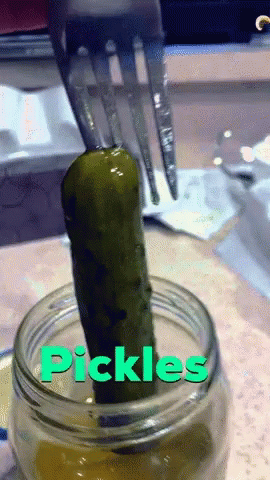 a tooth brush in a jar full of pickles