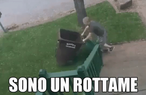a man is putting soing into a trash can