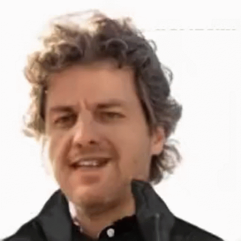 a man with curly hair wearing black jacket
