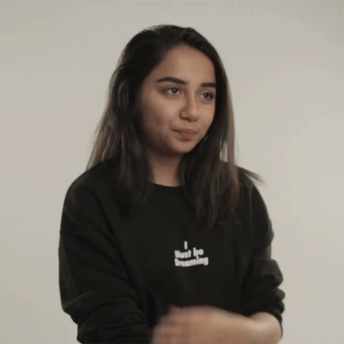 a girl wearing a black sweatshirt that says i hate her
