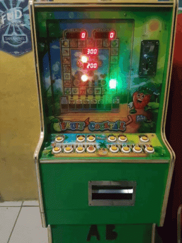 a green arcade machine on a tile floor