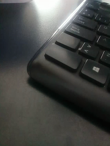 a closeup view of a computer keyboard with it's light on