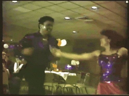 a man and woman dancing in a restaurant