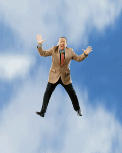 a man in a suit jumps into the air