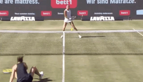 two women who are playing tennis on a court