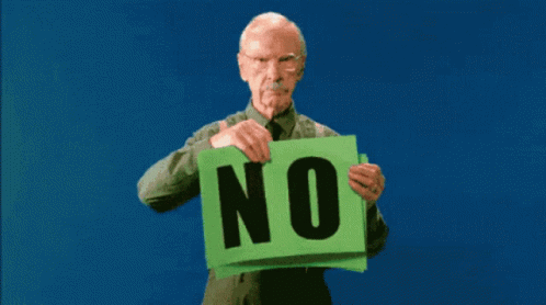 an older man is holding a green sign with the words no