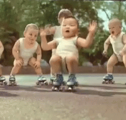 several baby dolls riding on skates on the ground