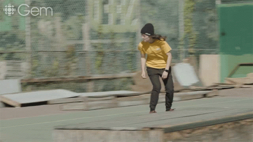 a girl riding a skateboard on the street