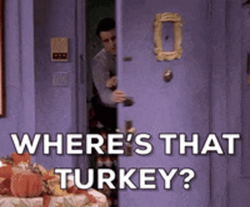 a man entering from a doorway with a turkey sitting on a table