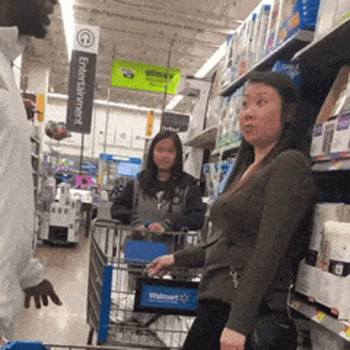 two women standing at a store cart with head phones on