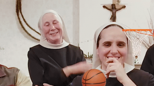 three nun - like women are laughing while holding basketballs