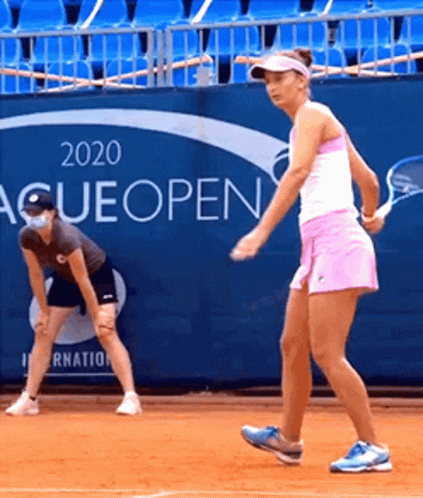 two women in different outfits playing tennis on the tennis court