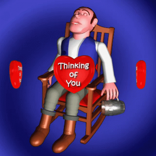 a guy sits on a rocking chair holding a heart