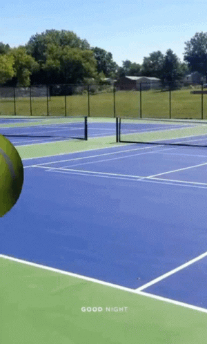 a person is swinging a tennis racket on a court