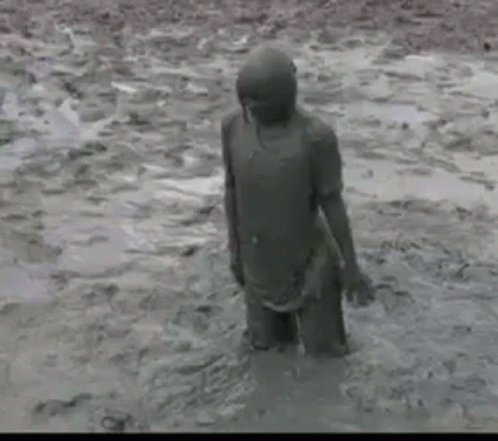 the child in the mud was looking out into the water