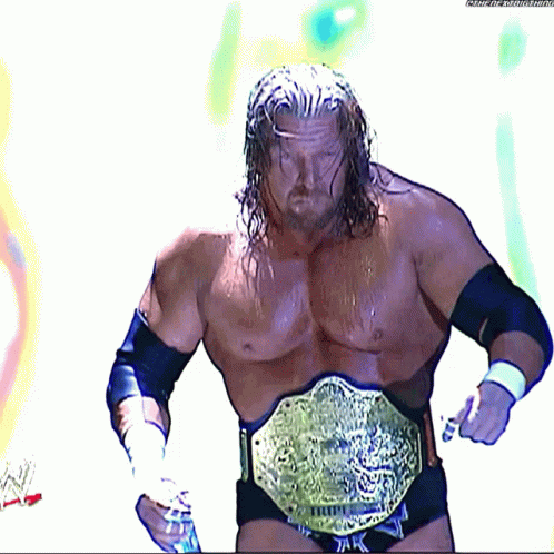 man with big, long beard wearing a silver wrestling belt