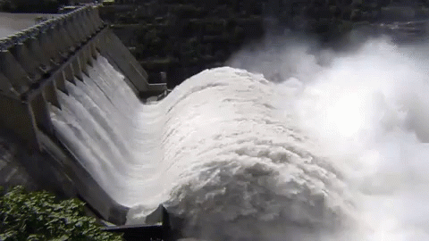 water gushing out of the side of a dam
