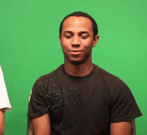 a man with blue skin is standing in front of a green screen