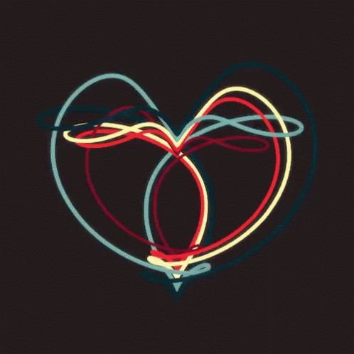 neon heart made from bright glowing lights on a dark background
