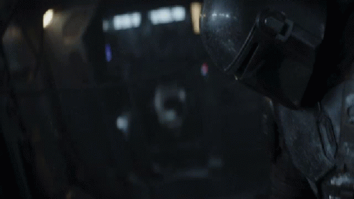 iron man in dark background facing right with white spots on his helmet