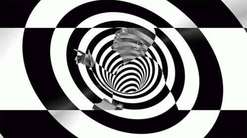 a black and white spiral pattern with a person standing at the center