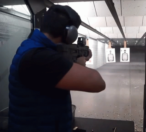 an image of a man shooting a rifle at target