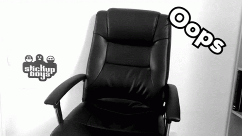 an office chair sits in front of a television