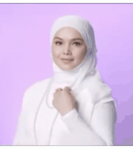 a po of a young woman wearing white in front of a pink backdrop