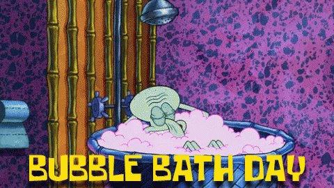 a purple bathroom with a pink bubble bath tub