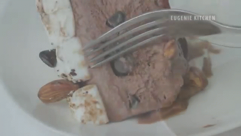 a fork with some cake on it near some fork