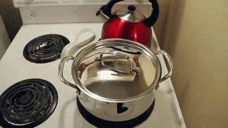 blue kettle on top of stove with silver pan