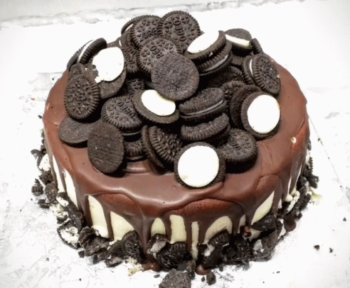 a cake topped with cookies and oreos on top of a white counter
