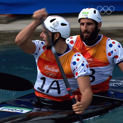 two olympic rowers paddle together in the water